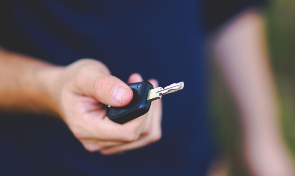 Man holding car keys after licence disqualification